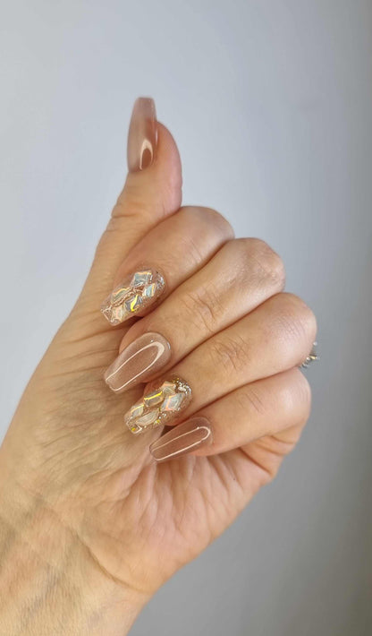 Close-up of a hand with long, almond-shaped Najma press-on nails.