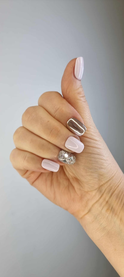 A hand giving a thumbs up, showcasing the Oman Opulence press-on nails set.