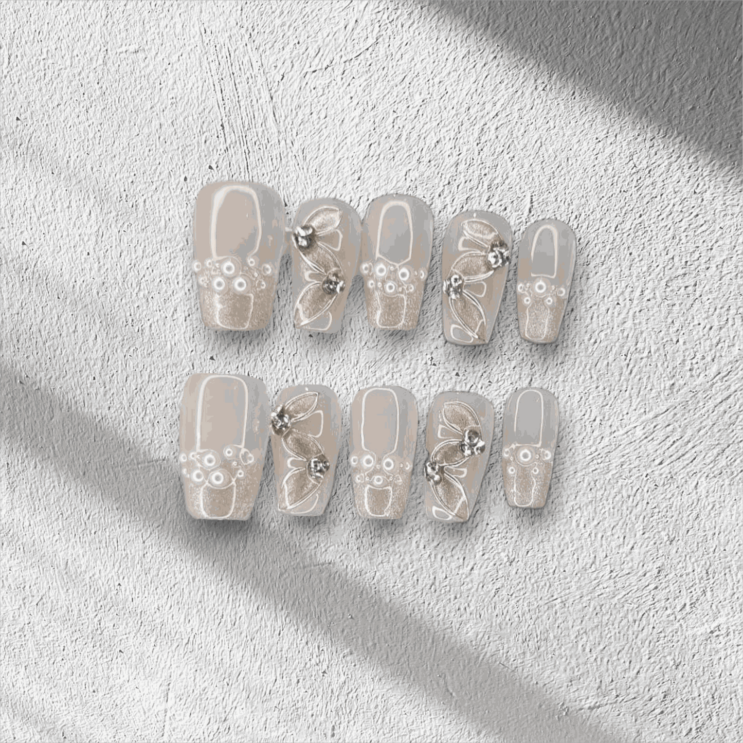 Full set of Palm Jumeirah Perfection press-on nails in a coffin shape, displayed in the box.