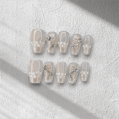 Full set of Palm Jumeirah Perfection press-on nails in a coffin shape, displayed in the box.