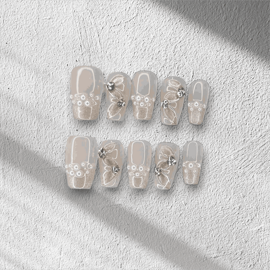 Full set of Palm Jumeirah Perfection press-on nails in a coffin shape, displayed in the box.