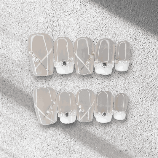 Full set of Pearl of Qatar press-on nails in a square shape, displayed in the box.