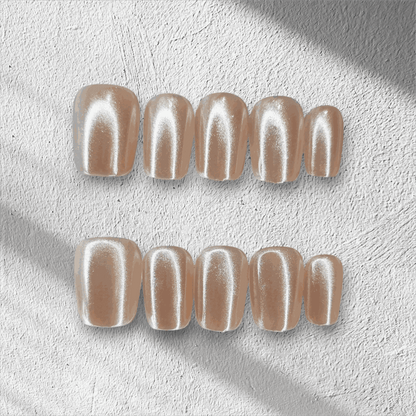 Full set of Pearls of Bahrain press-on nails in a short square shape, displayed in packaging.