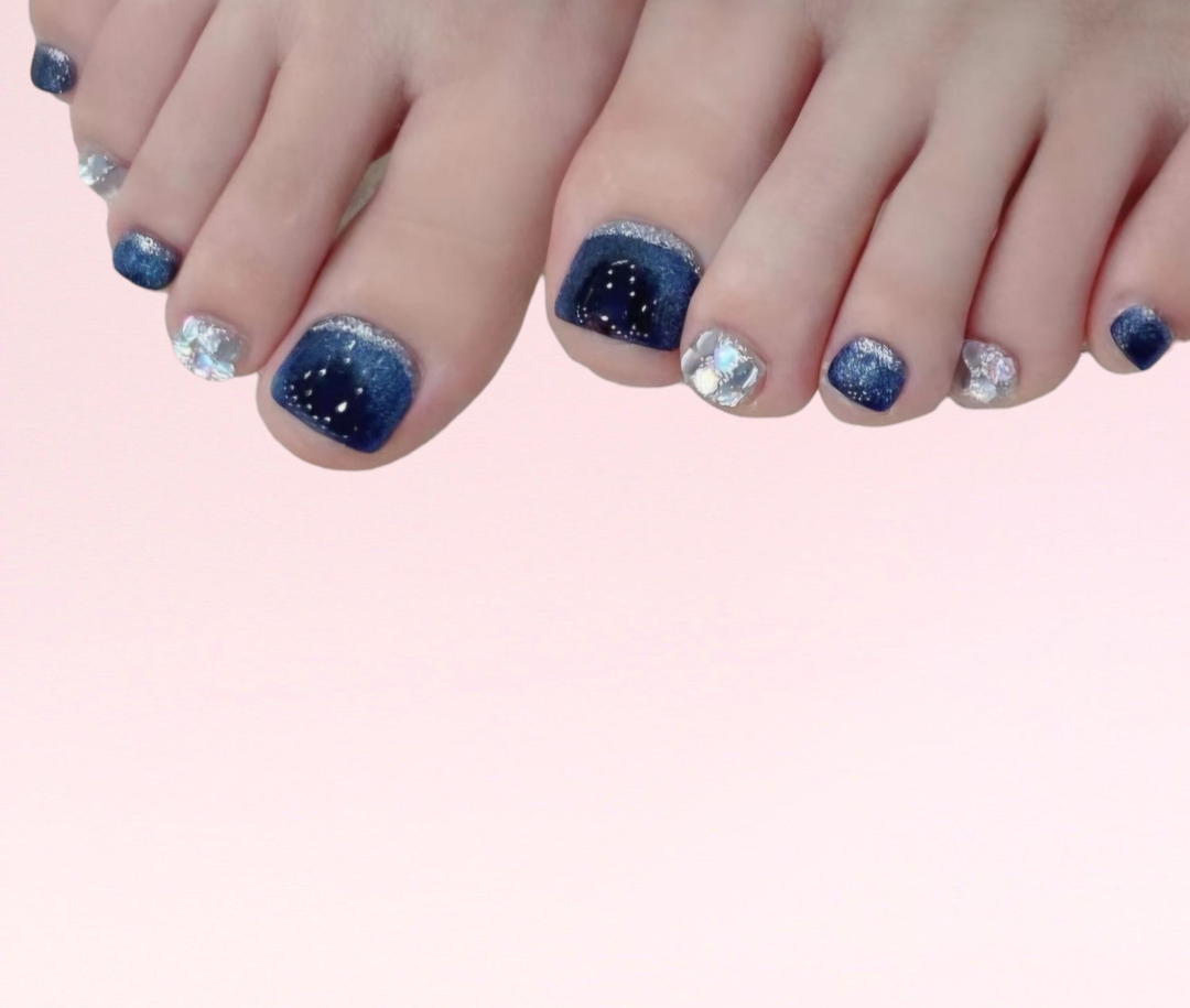 A pair of feet showing the vibrant, colorful Naaz pedi press-on toe nails set.