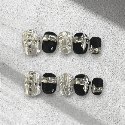 Full set of black and silver glossy press-on nails from the Qatar Elegance collection displayed in the box.