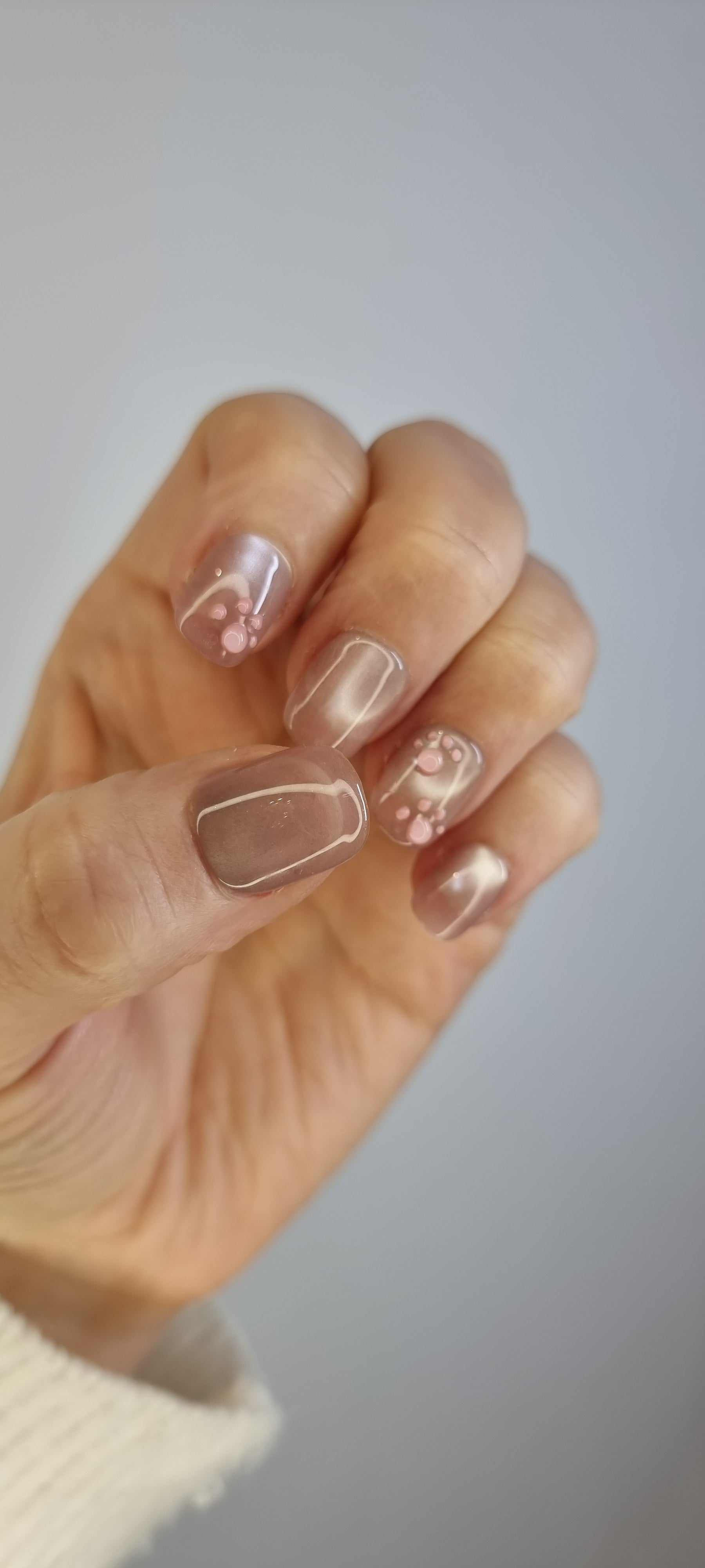 Close-up of Qita glossy, neutral-toned press-on nails.
