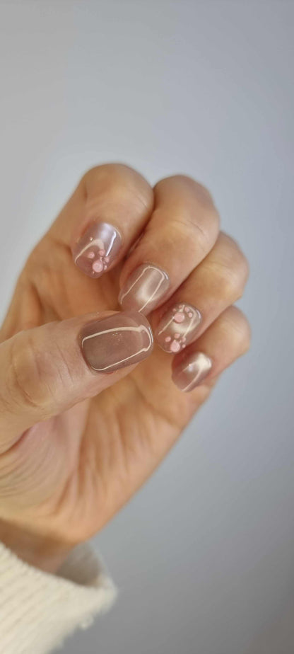 Close-up of Qita glossy, neutral-toned press-on nails.