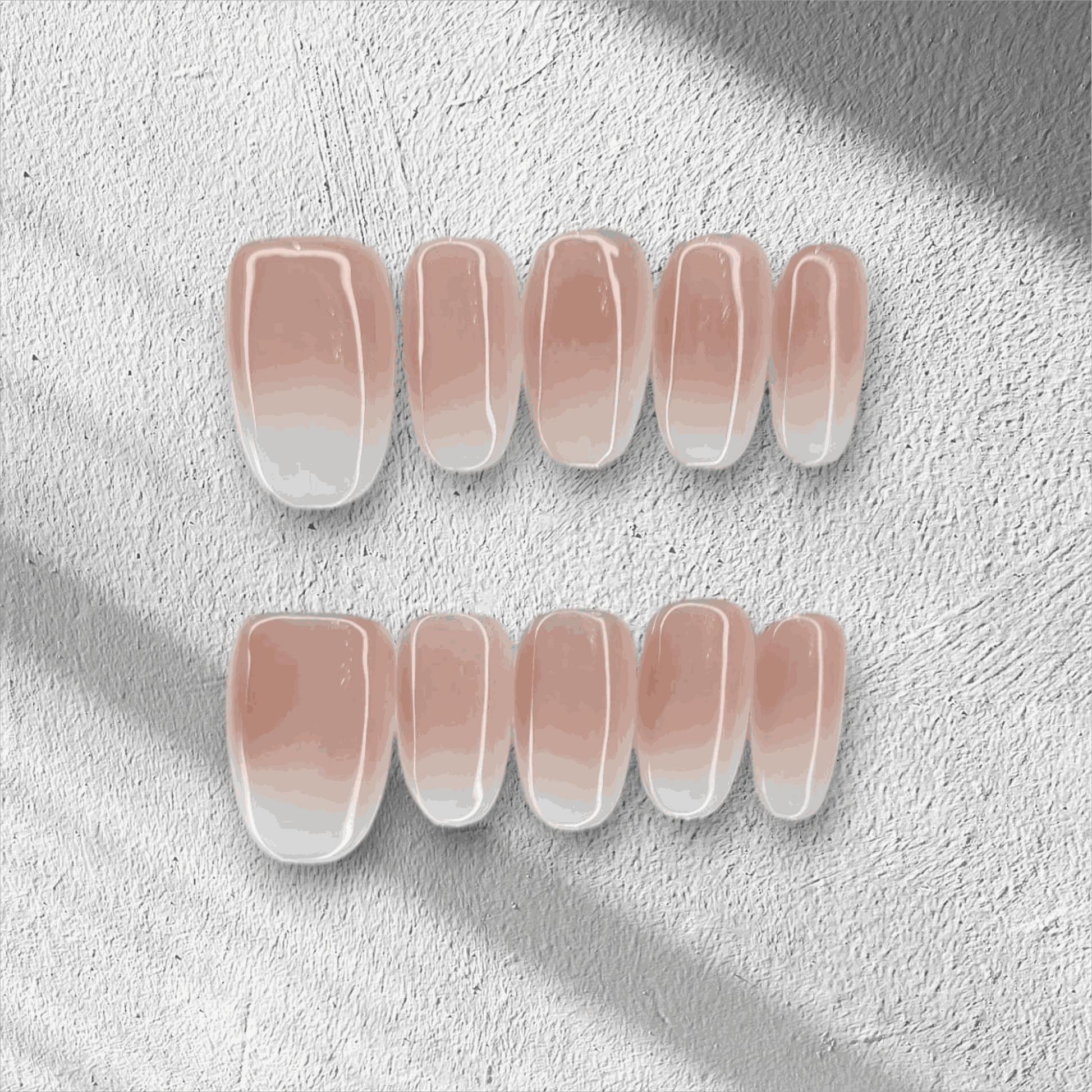 The Raneem press-on nail set in a short almond shape with an ombre design.