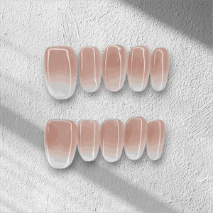 The Raneem press-on nail set in a short almond shape with an ombre design.