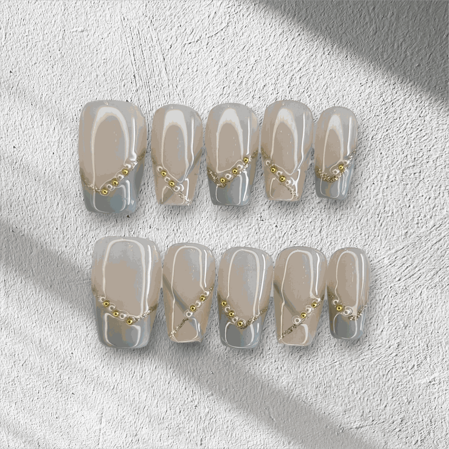 Full set of Ranya translucent press-on nails with a sparkle design, displayed in the box.