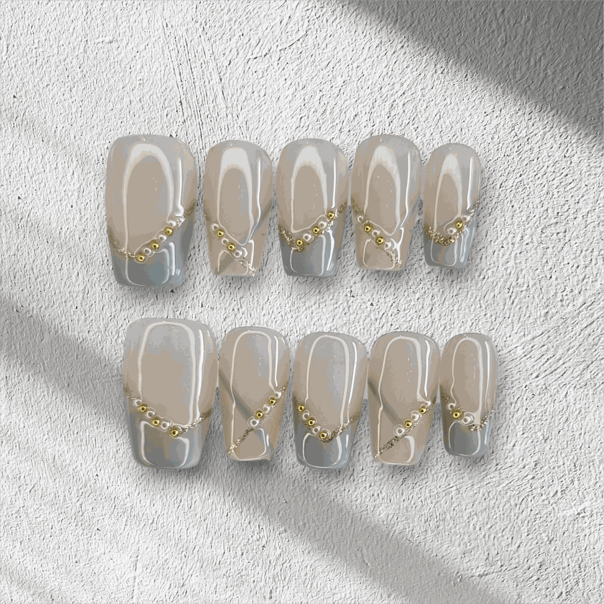 Full set of Ranya translucent press-on nails with a sparkle design, displayed in the box.