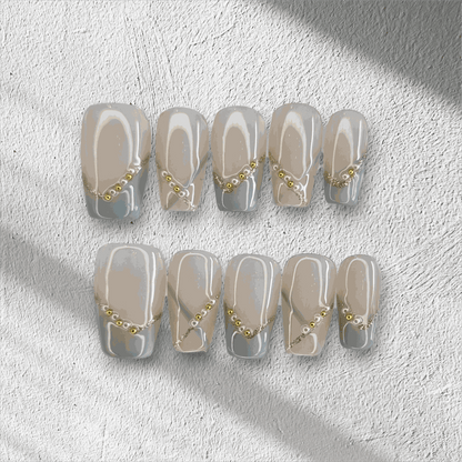 Full set of Ranya translucent press-on nails with a sparkle design, displayed in the box.