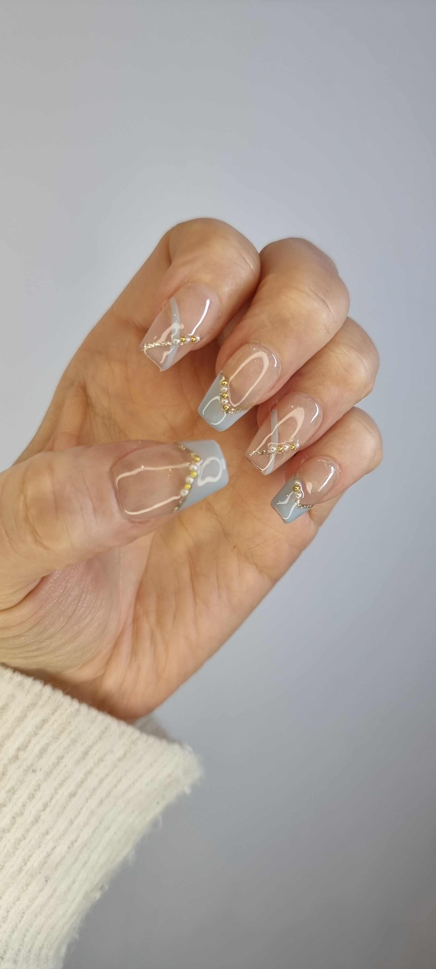 Close-up of Ranya translucent press-on nails showing the subtle sparkle or gem detail.