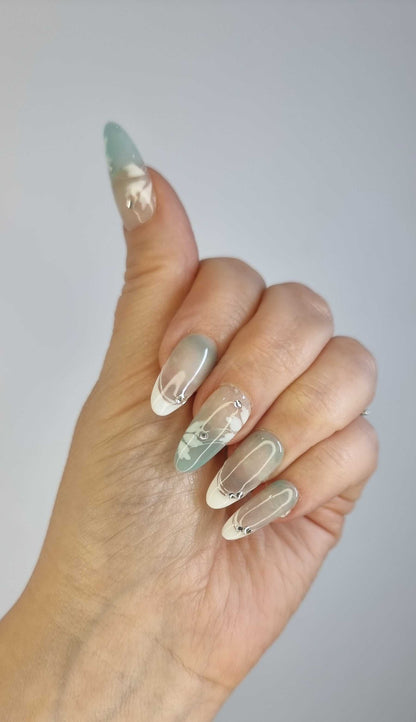 Set of glossy, translucent off-white Rawan press-on nails.