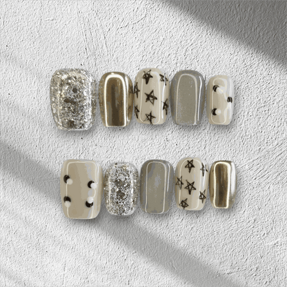 Full set of Reemisland glossy, neutral-toned press-on nails displayed in the box.