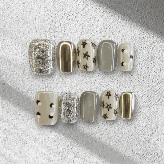 Full set of Reemisland glossy, neutral-toned press-on nails displayed in the box.