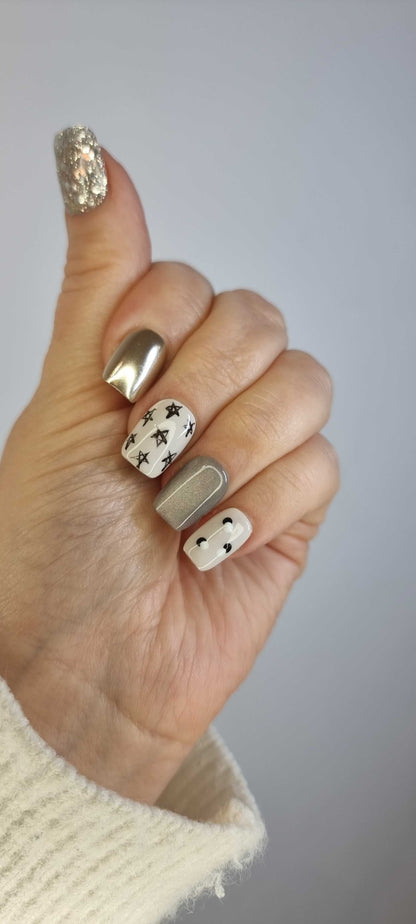 Set of Reemisland glossy, neutral-toned press-on nails, showing design details.