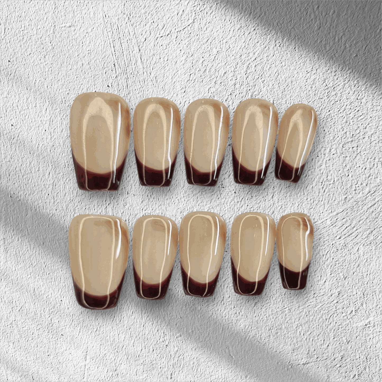 The Riham press-on nail set in a long coffin shape, displayed in the box.