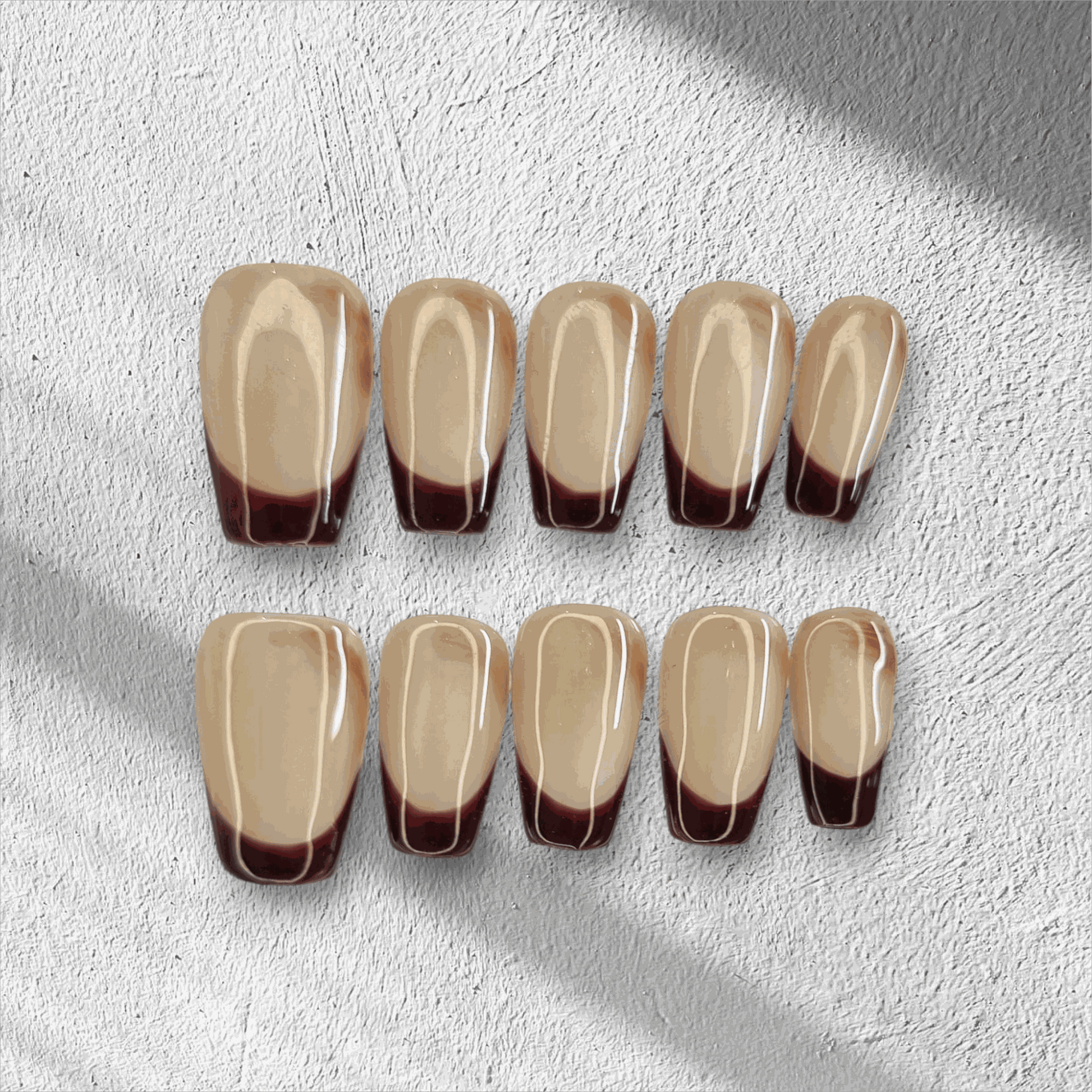 The Riham press-on nail set in a long coffin shape, displayed in the box.