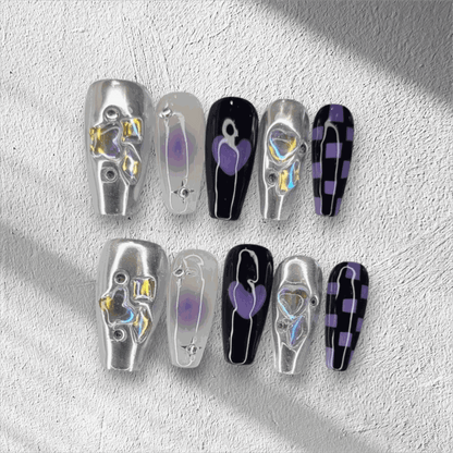 Full set of Riyadh Radiance silver, glossy, and black press-on nails displayed in the box.