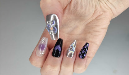 Close-up of the Riyadh Radiance silver, glossy, and black press-on nails.