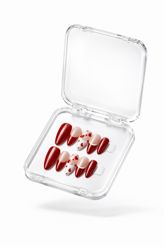 Set of red press-on nails , by Nail addict uae. in a clear case on a white background