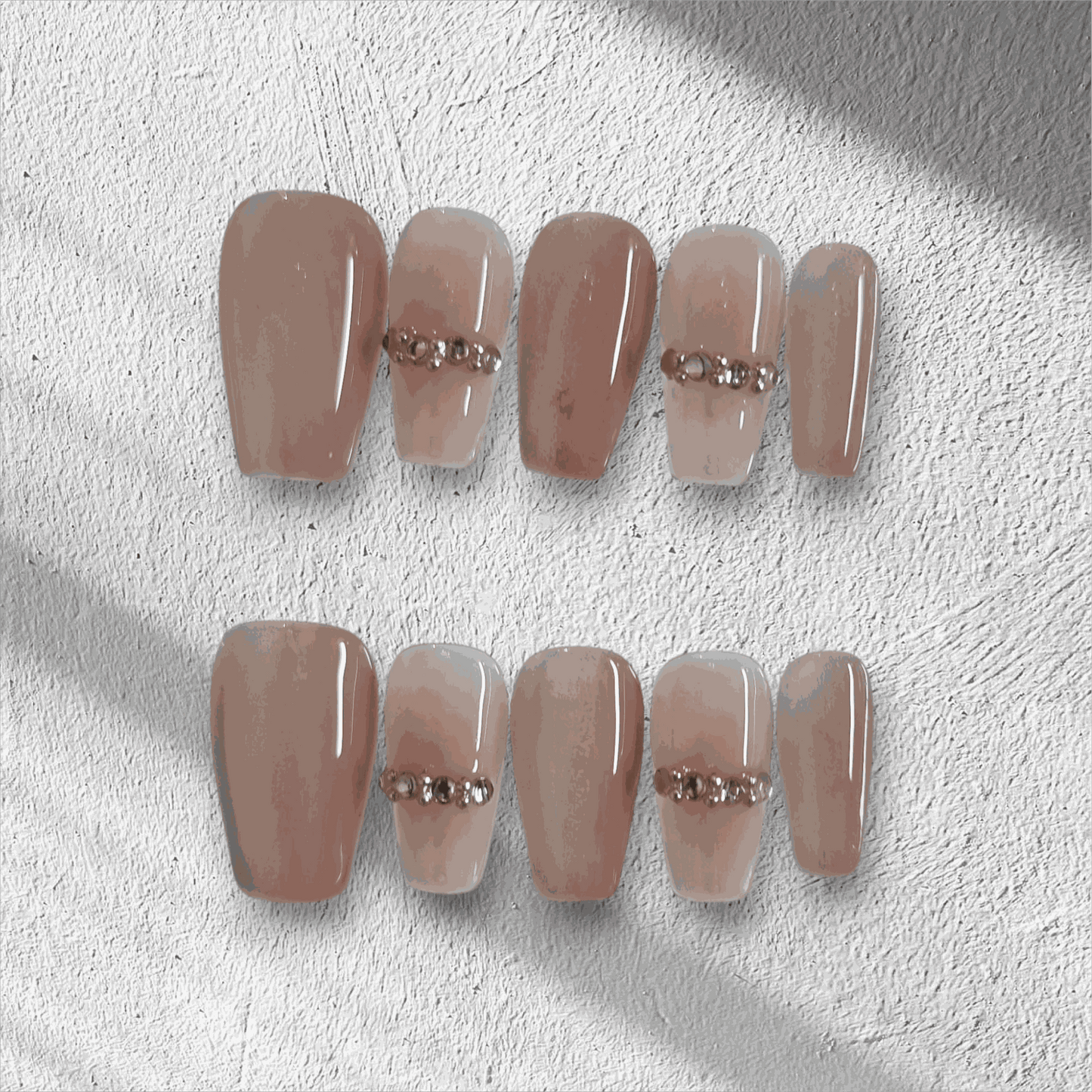 Full set of Sabah cream and white long coffin press-on nails displayed in the box.