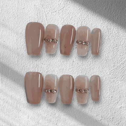 Full set of Sabah cream and white long coffin press-on nails displayed in the box.