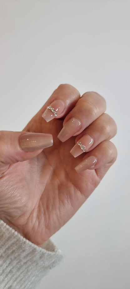 Hand wearing Sabah long coffin press-on nails, showing the shape and length.