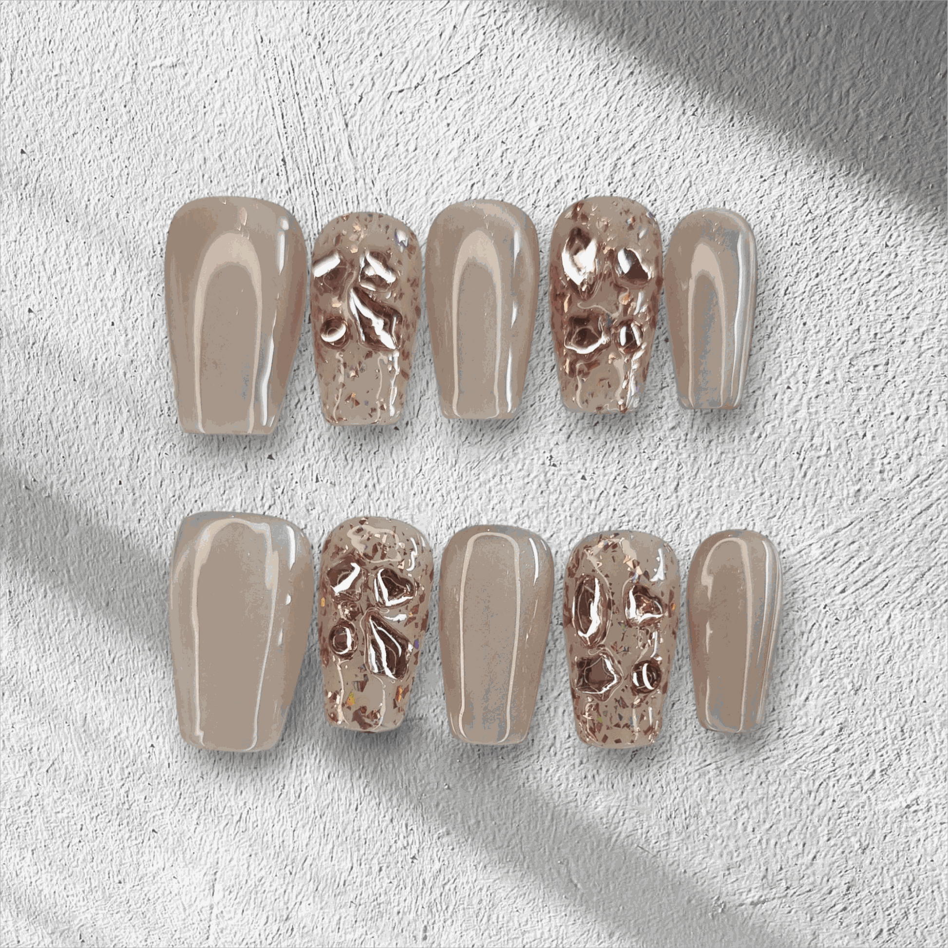 Full set of Sadeen nude press-on nails with a glossy finish, displayed in the box.