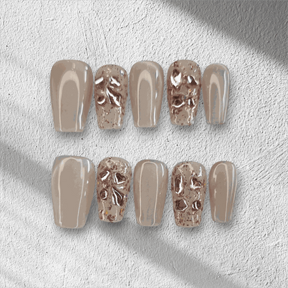 Full set of Sadeen nude press-on nails with a glossy finish, displayed in the box.