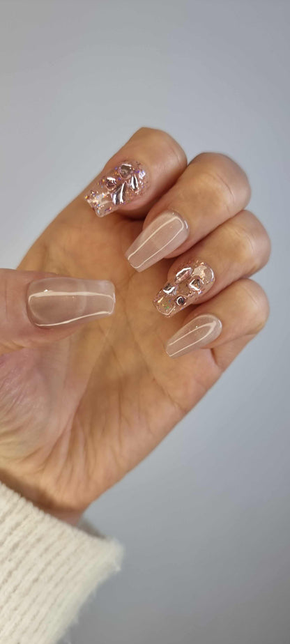 Close-up of Sadeen nude press-on nails showing the glossy finish.