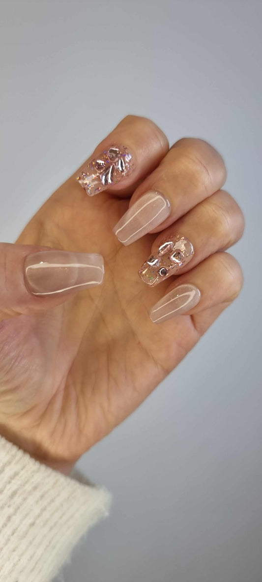 Close-up of Sadeen nude press-on nails showing the glossy finish.
