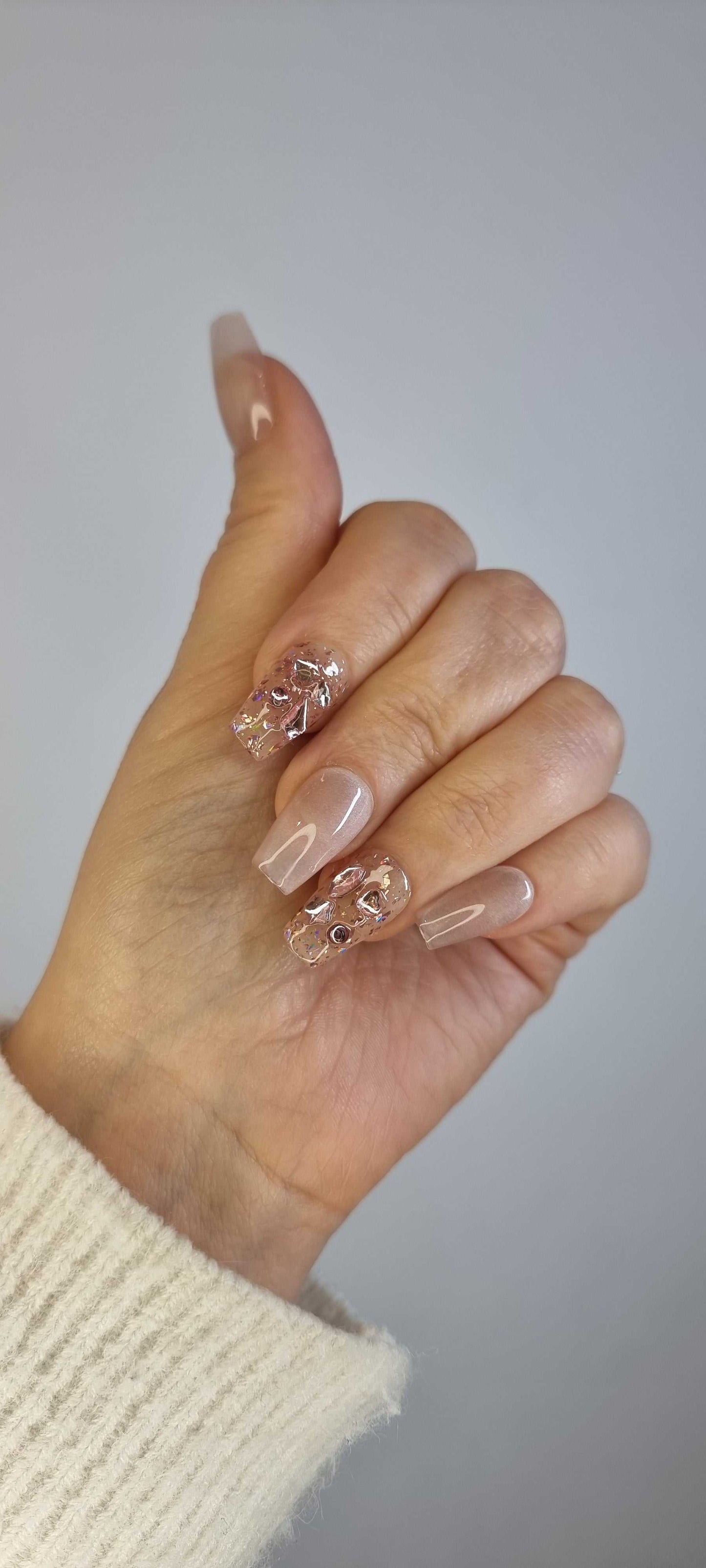Set of Sadeen nude press-on nails with a smooth, glossy finish.