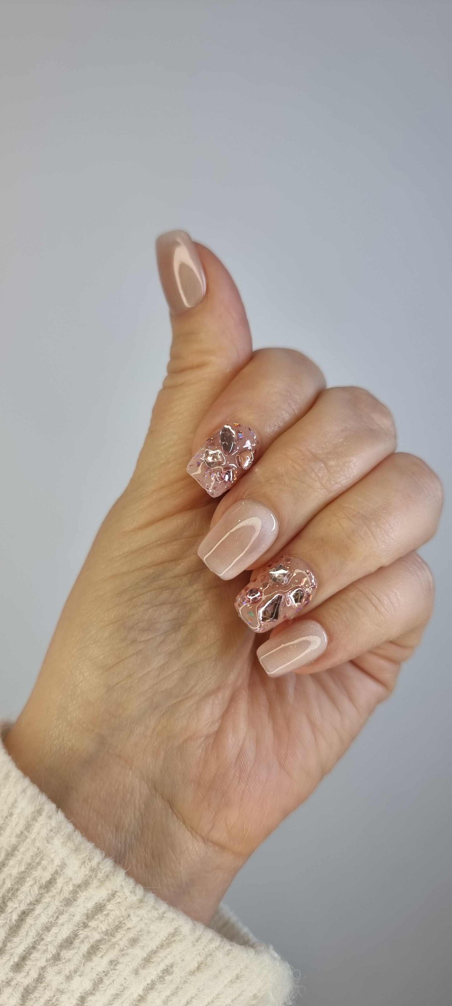 Close-up of a model wearing the Sadeen Short nude press-on nails, showing length.