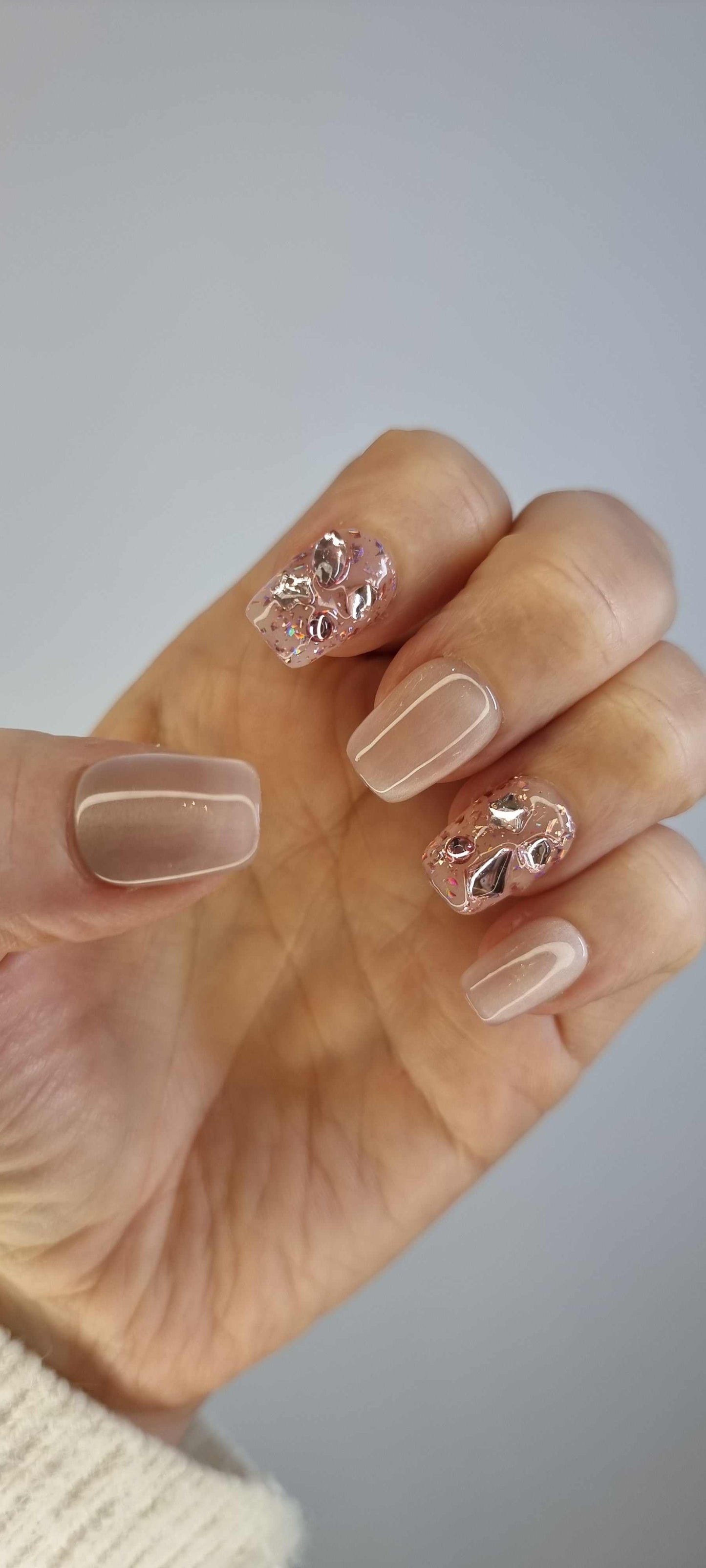 Image of the Sadeen Short nude glossy press-on nails set, showing a different angle or hand.