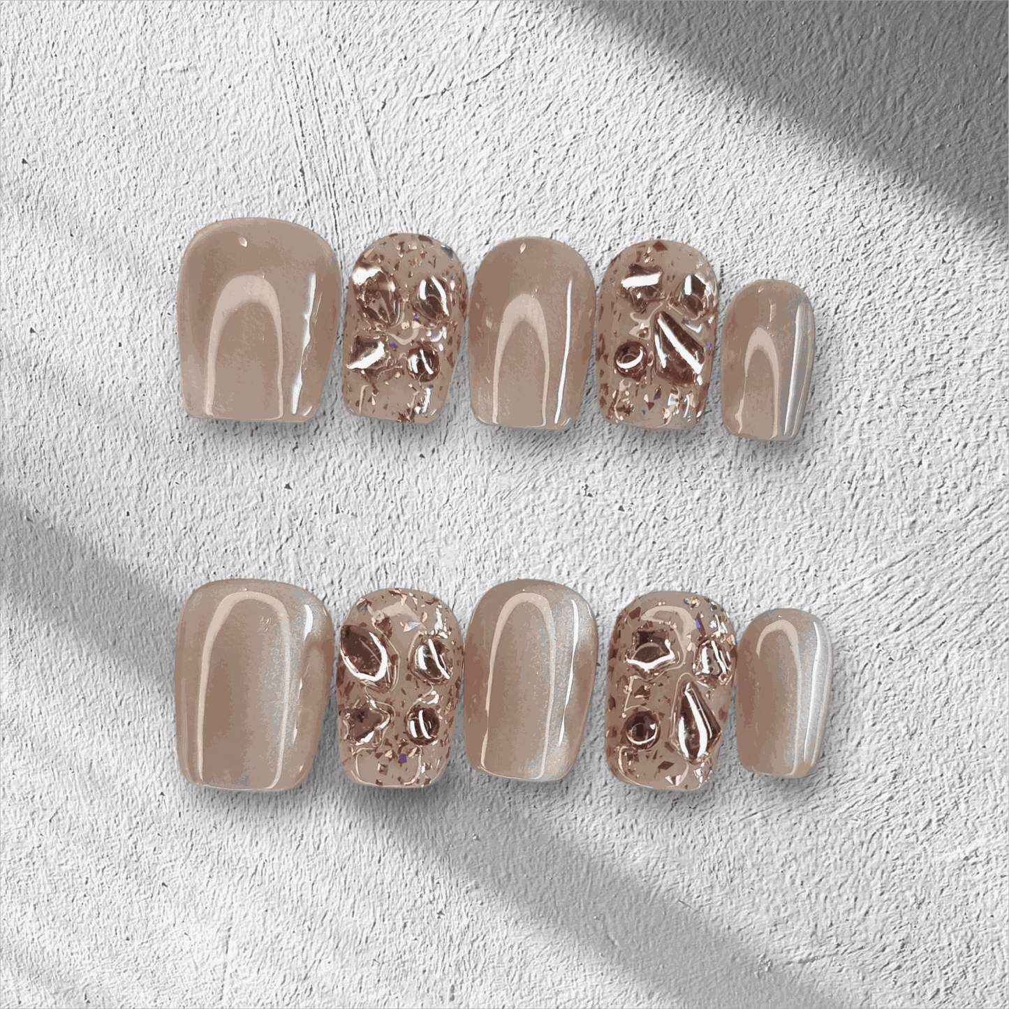 A full set of the Sadeen Short nude press-on nails with a high-gloss finish, displayed.