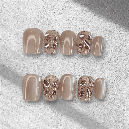 A full set of the Sadeen Short nude press-on nails with a high-gloss finish, displayed.