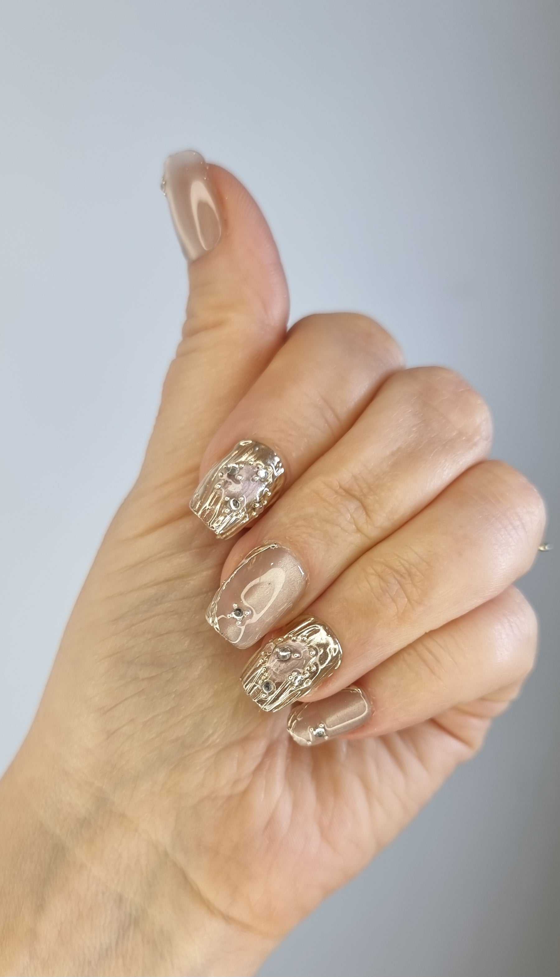Set of metallic gold, coffin-shaped Sama Short press-on nails.
