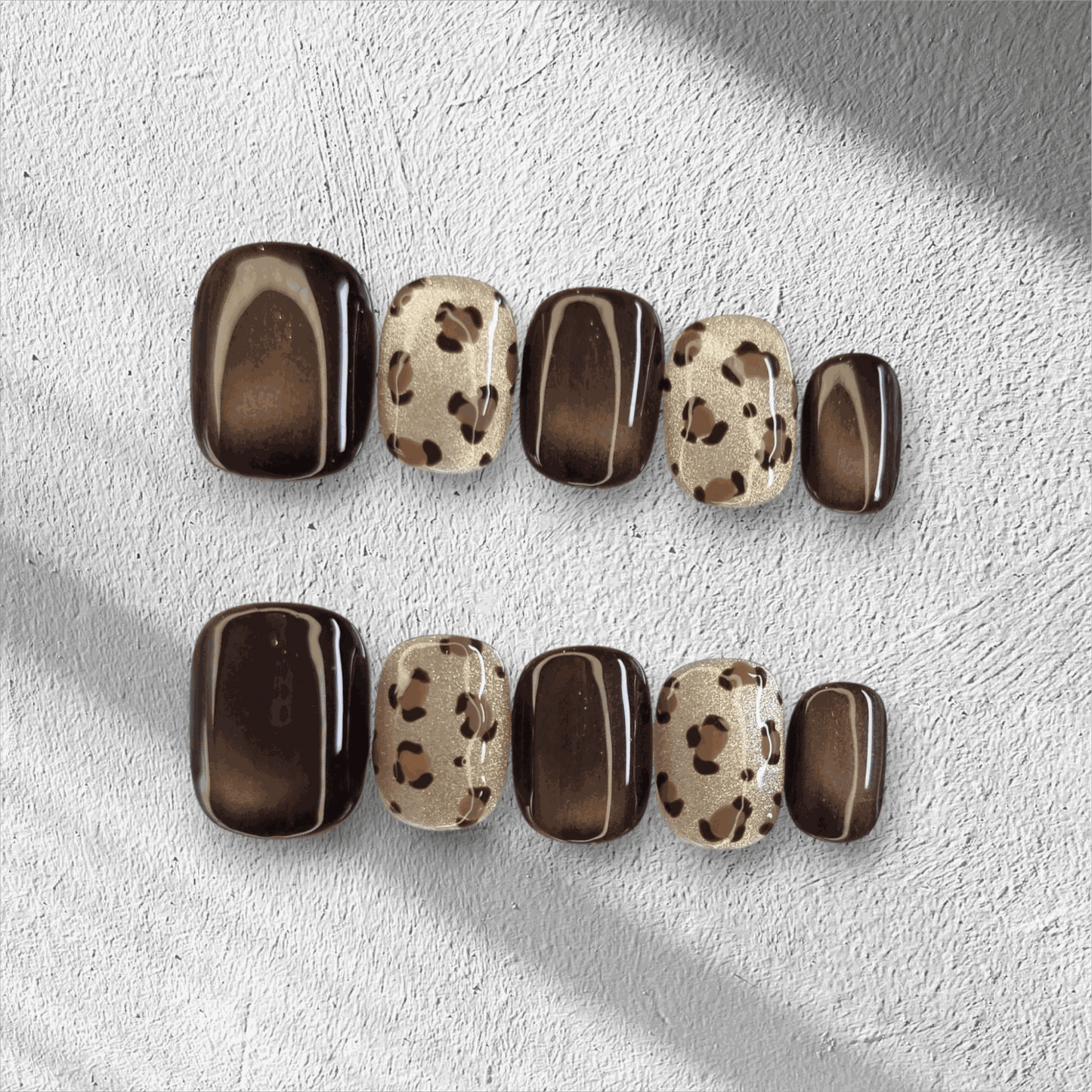 Full set of Shaheen false press-on nails with an animal print design displayed in the box.