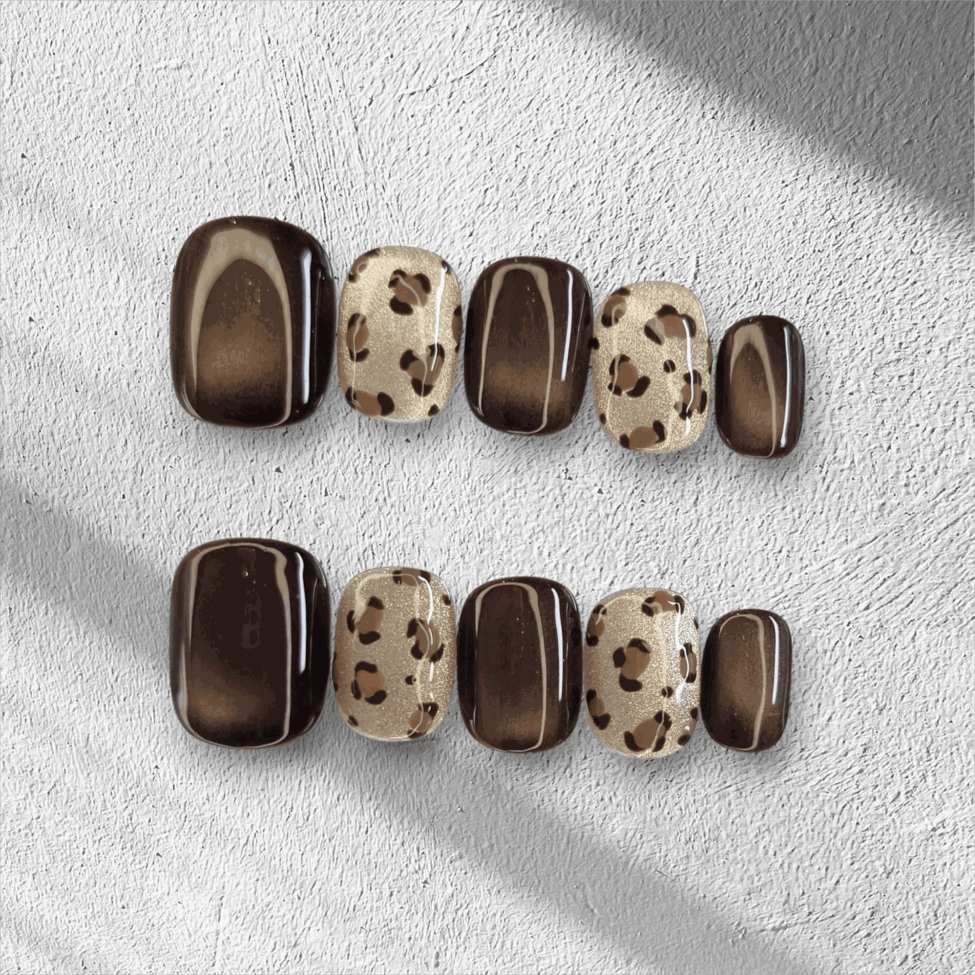 Full set of Shaheen false press-on nails with an animal print design displayed in the box.