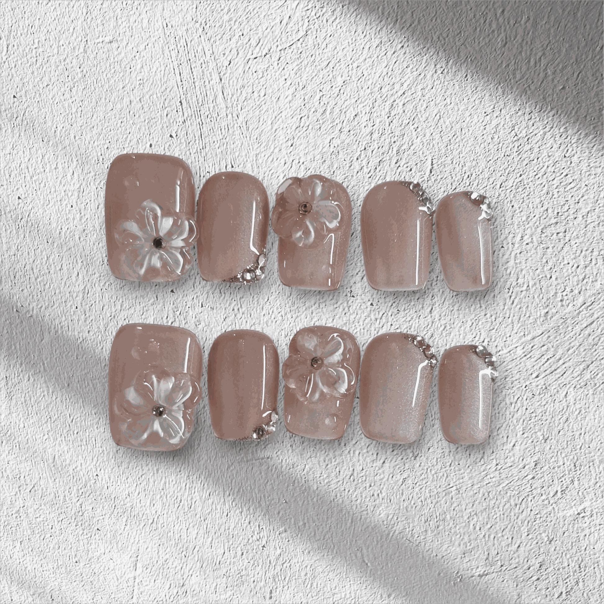 Full set of Shaima false press-on nails in a glossy, light brown color displayed in the box.