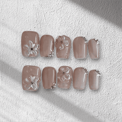 Full set of Shaima false press-on nails in a glossy, light brown color displayed in the box.