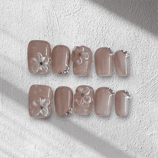 Full set of Shaima false press-on nails in a glossy, light brown color displayed in the box.