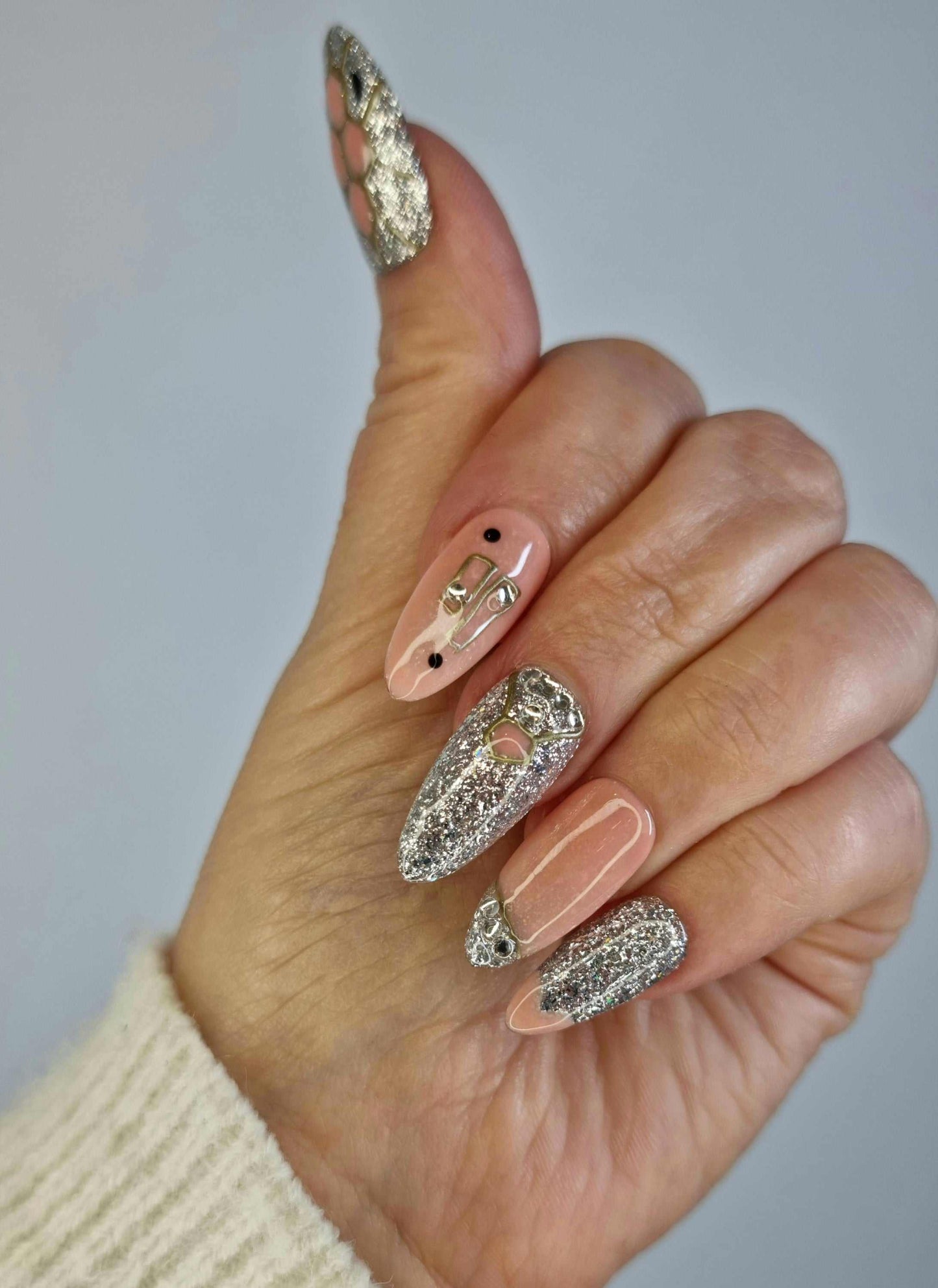 Close-up of the Sharjah Sparkle nude, almond-shaped press-on nails set.