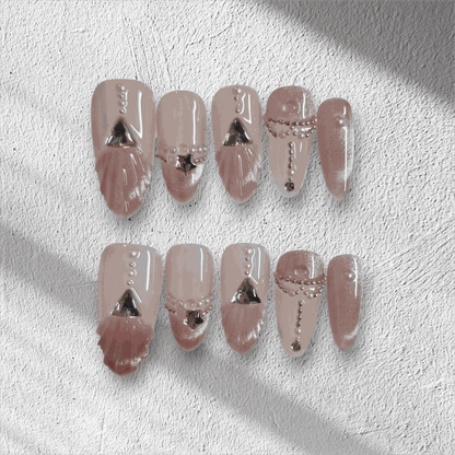 Full set of Sharqiya Shine nude, almond-shaped press-on nails displayed in the box.