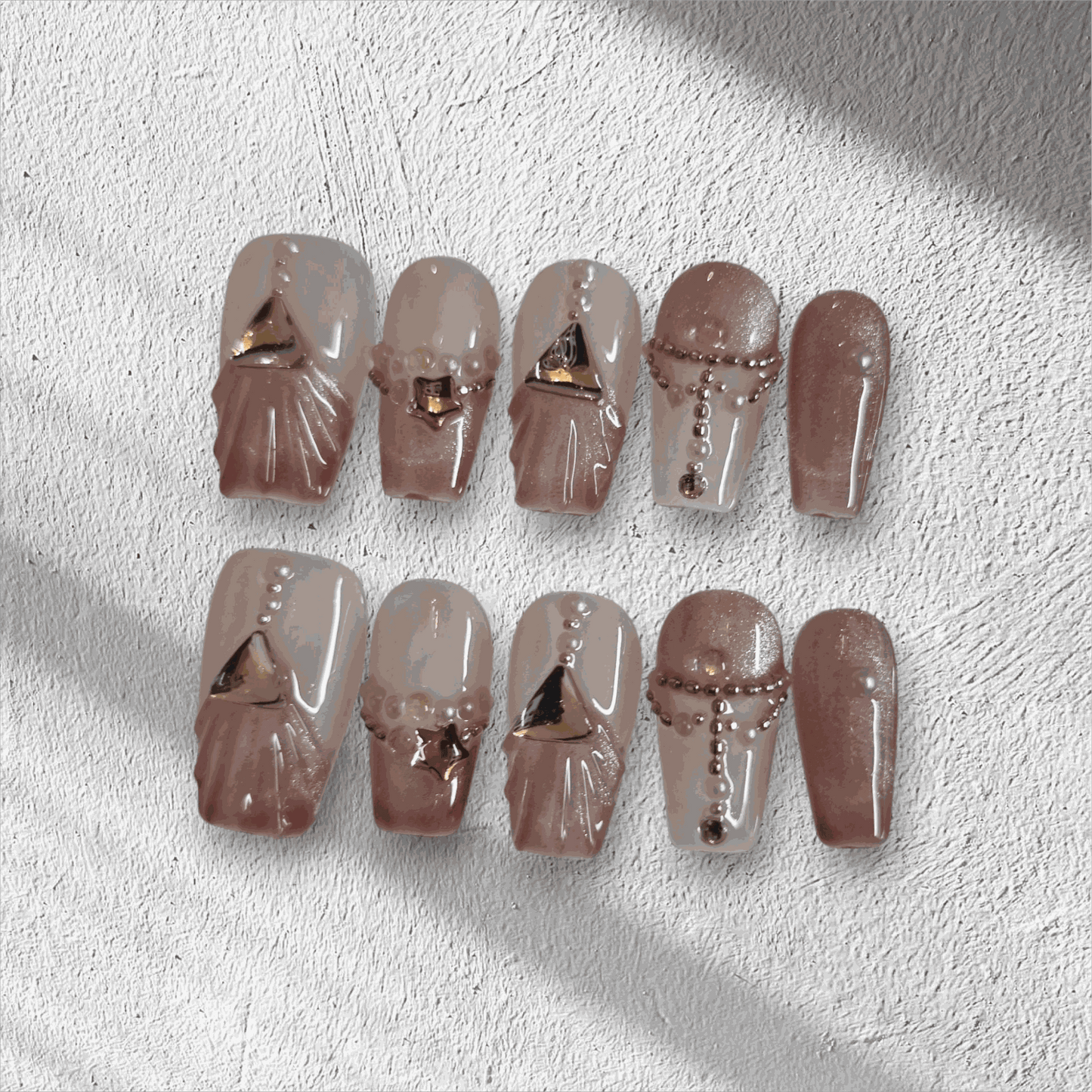 Full set of Sharqiya Shine nude, coffin-shaped press-on nails displayed in the box.
