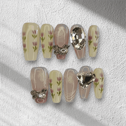 Full set of Sophia light, neutral-toned press-on nails displayed in the box.