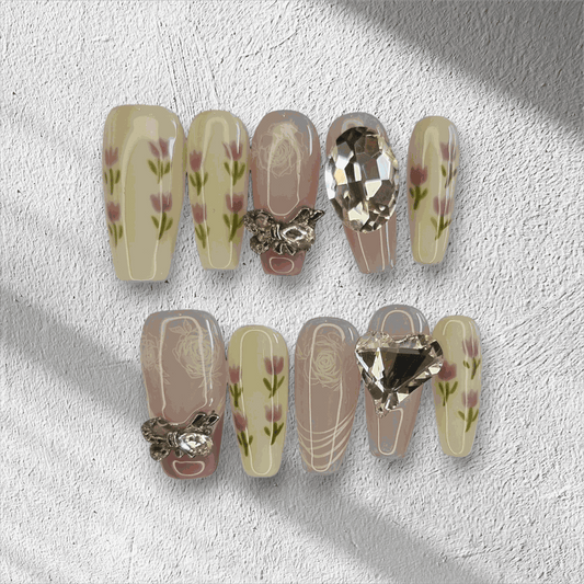 Full set of Sophia light, neutral-toned press-on nails displayed in the box.