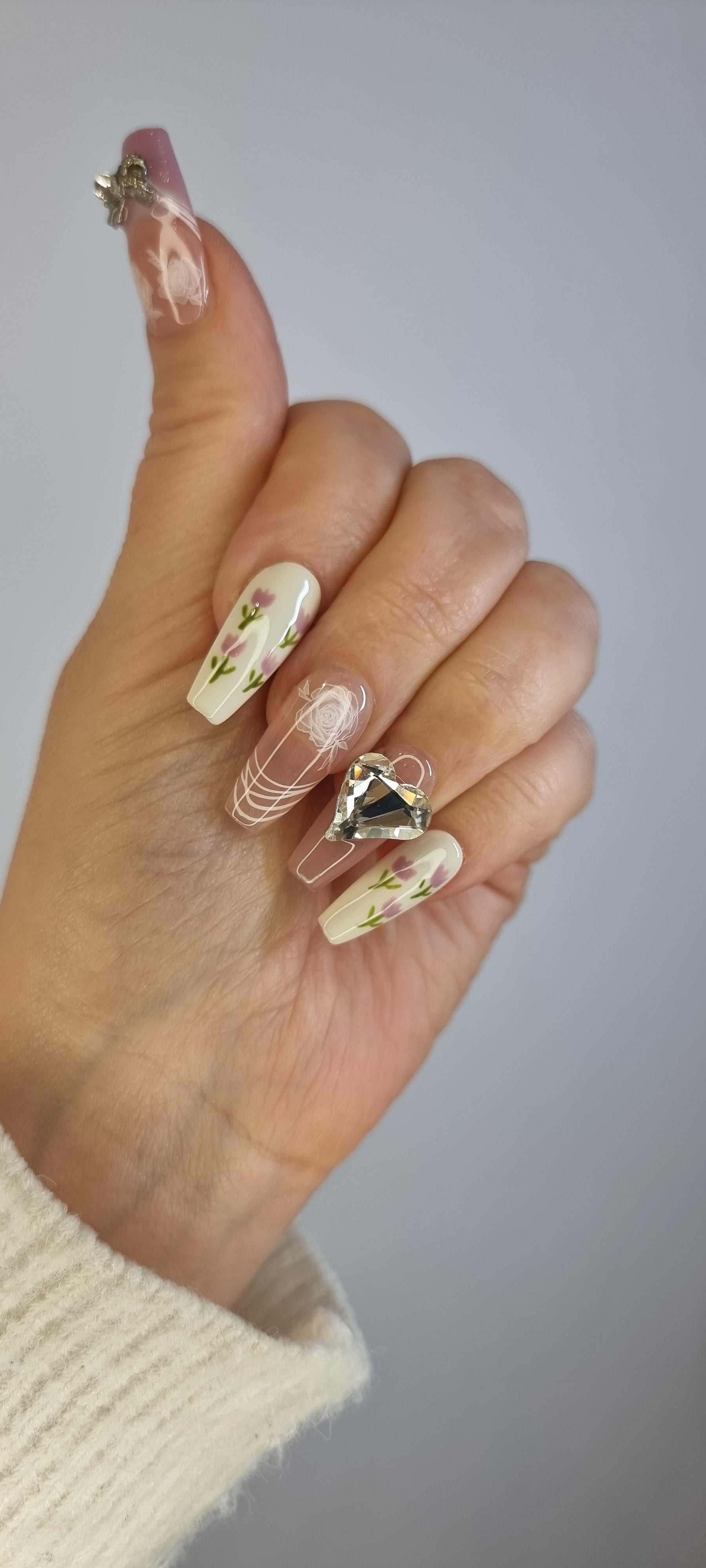 Set of Sophia light, neutral-toned press-on nails, showing various sizes.